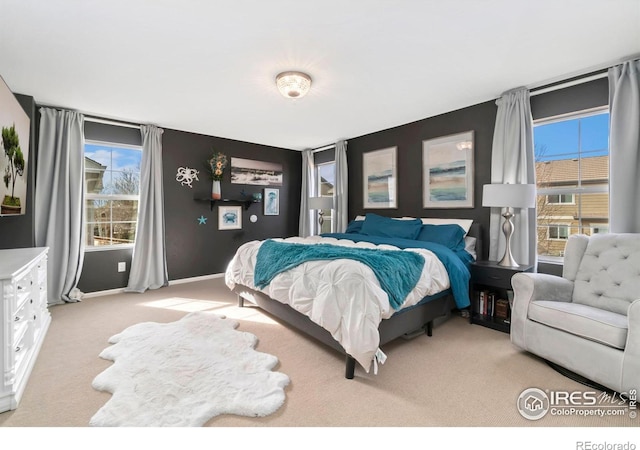 carpeted bedroom with multiple windows and baseboards