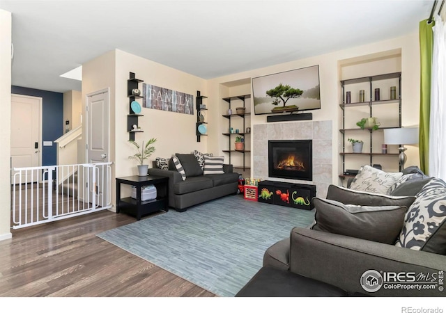 living room featuring wood finished floors and a tile fireplace