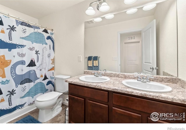 full bath featuring double vanity, toilet, visible vents, and a sink