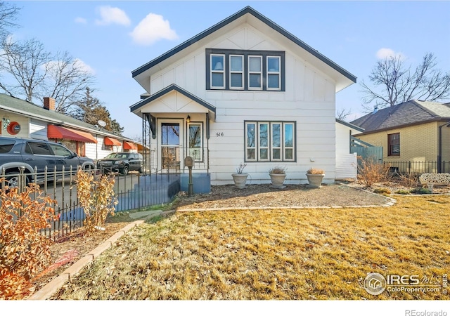 view of front of house with board and batten siding and a fenced front yard