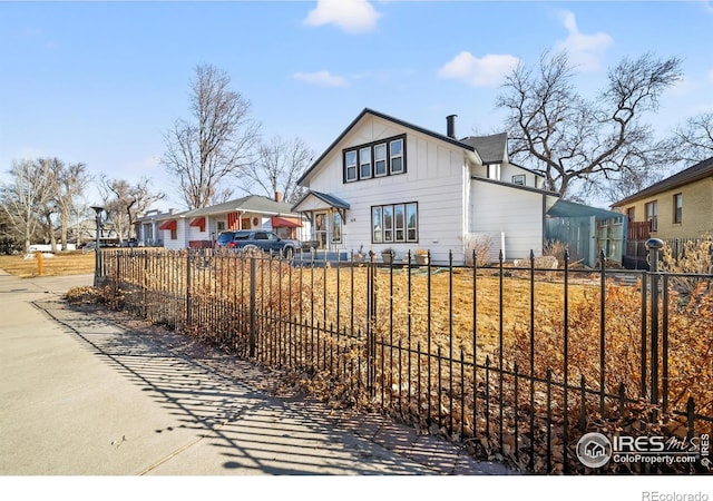 view of front of property with a fenced front yard and board and batten siding