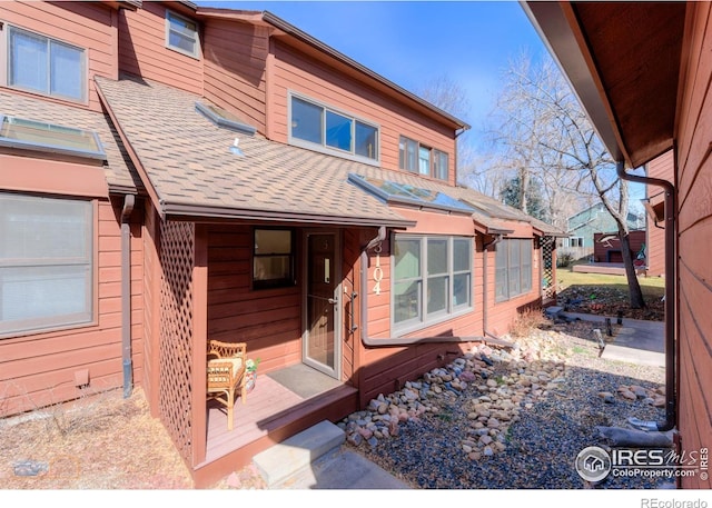 exterior space with a shingled roof