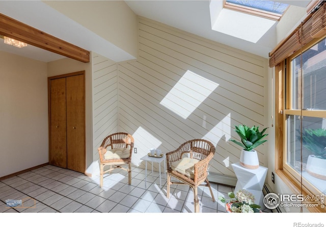 interior space with light tile patterned flooring, wooden walls, a skylight, and beam ceiling