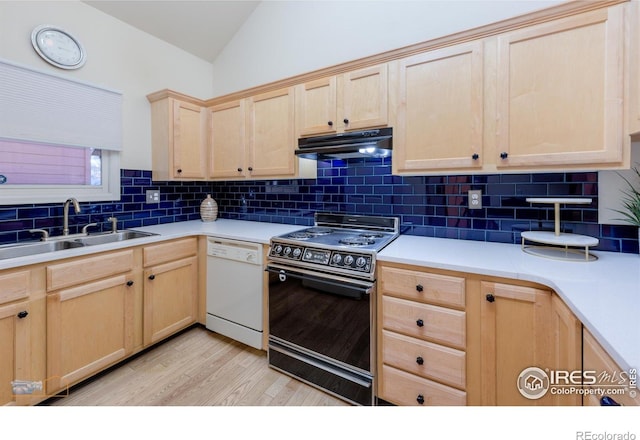 kitchen featuring under cabinet range hood, white dishwasher, electric range oven, and light brown cabinetry