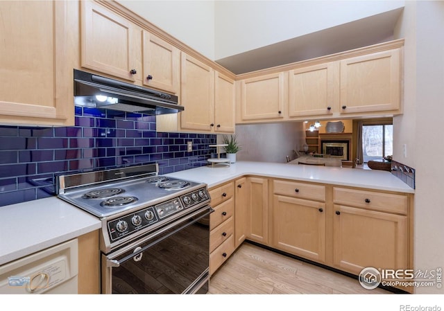 kitchen featuring under cabinet range hood, electric range oven, and light brown cabinetry