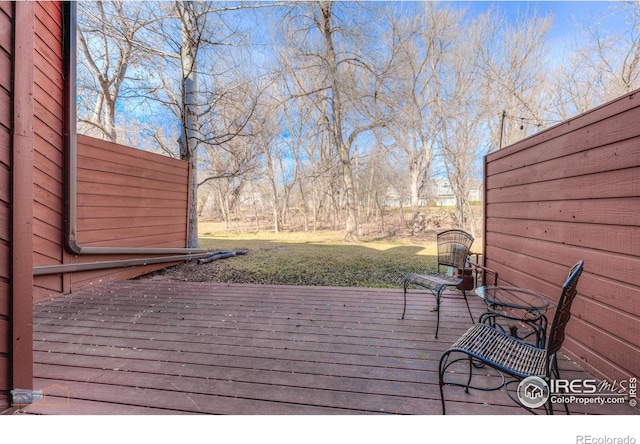 wooden terrace with a yard