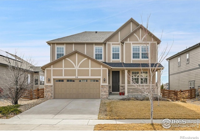 view of front facade with a shingled roof, covered porch, stucco siding, a garage, and driveway