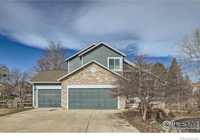 view of front of home with stone siding, driveway, an attached garage, and a shingled roof