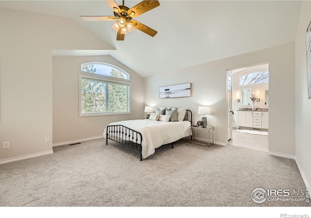 carpeted bedroom featuring ceiling fan, baseboards, ensuite bathroom, and lofted ceiling