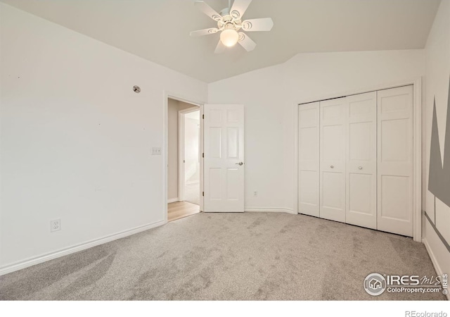 unfurnished bedroom with ceiling fan, baseboards, lofted ceiling, carpet floors, and a closet