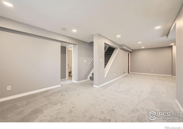 finished basement featuring recessed lighting, stairway, baseboards, and carpet flooring