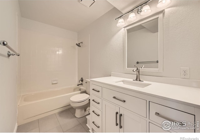 bathroom with vanity, tile patterned flooring, bathtub / shower combination, toilet, and a textured wall