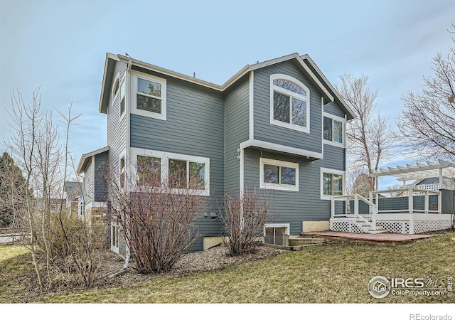 back of house with a wooden deck, a lawn, a pergola, and central AC