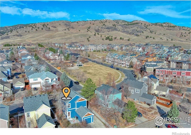 drone / aerial view featuring a residential view and a mountain view