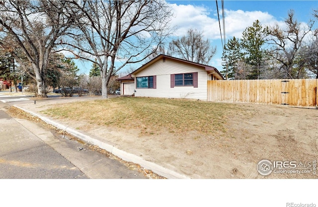 view of front of house with a front yard and fence