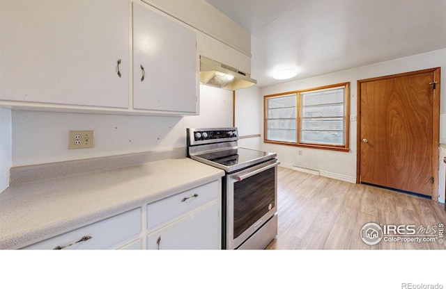 kitchen with under cabinet range hood, light wood-type flooring, light countertops, stainless steel range with electric cooktop, and white cabinets