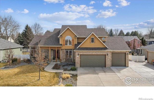 view of front of property featuring brick siding, a front lawn, fence, concrete driveway, and a garage