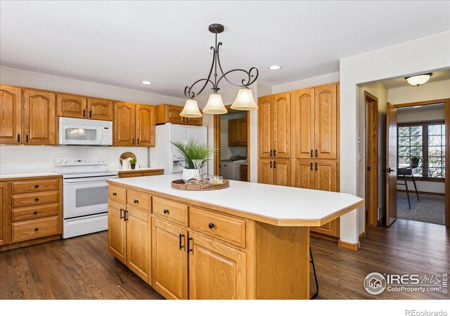 kitchen with decorative light fixtures, dark wood finished floors, a center island, white appliances, and light countertops