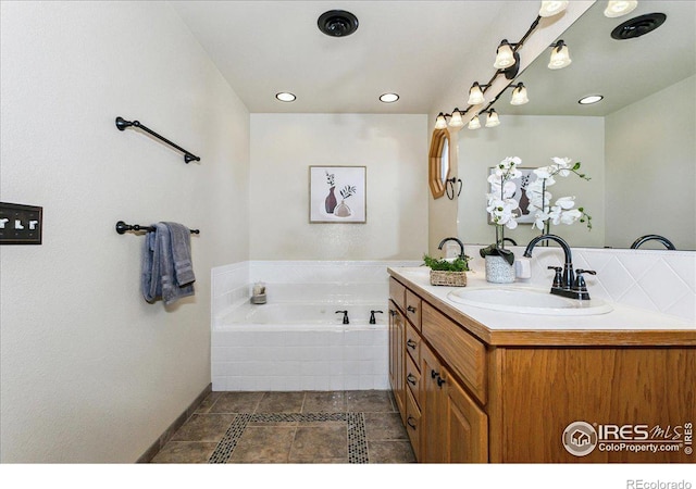 full bath featuring vanity, a garden tub, recessed lighting, and tile patterned floors