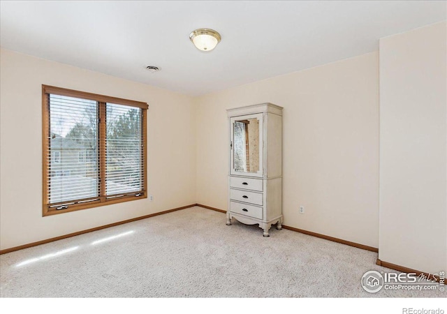 unfurnished bedroom featuring baseboards and carpet