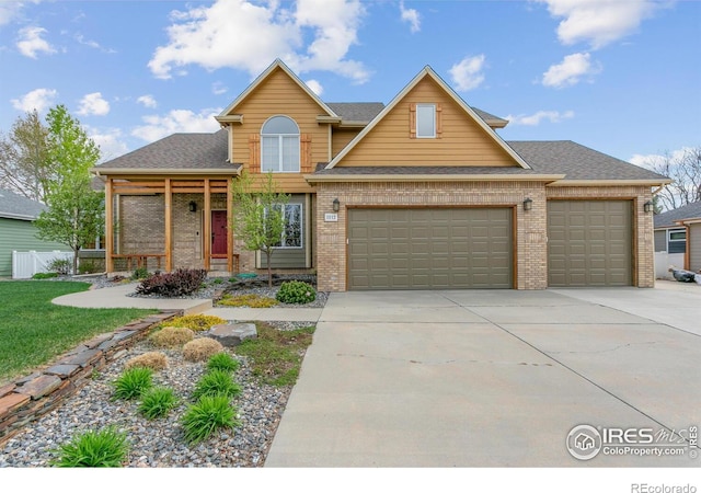 traditional-style home with brick siding, a garage, driveway, and a shingled roof