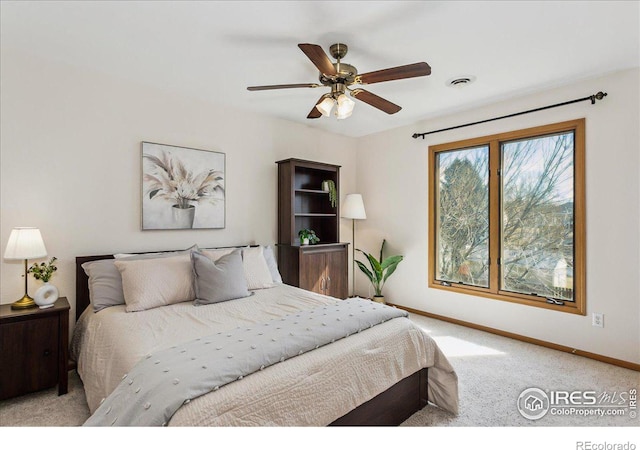 bedroom with visible vents, carpet flooring, baseboards, and ceiling fan