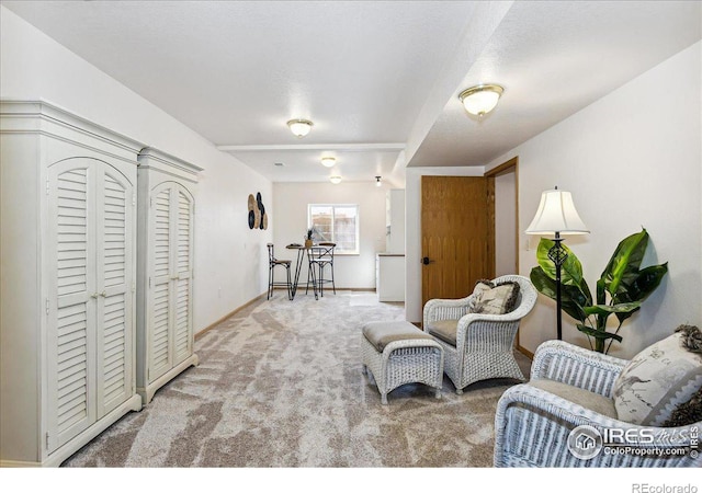 sitting room with carpet and baseboards