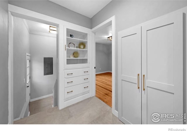 interior space featuring electric panel and light wood-style flooring