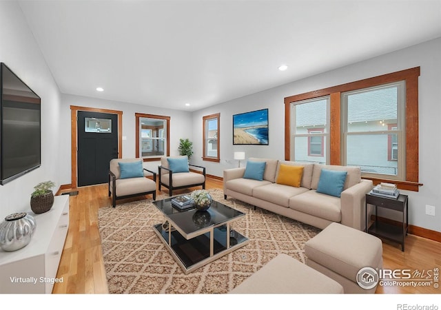 living room featuring recessed lighting, a healthy amount of sunlight, and wood finished floors