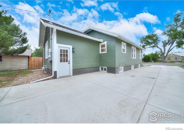 back of house featuring a patio area and fence