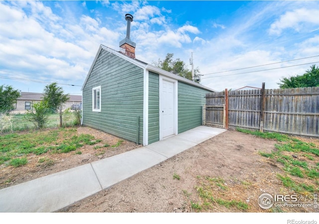 view of outbuilding with an outdoor structure and fence