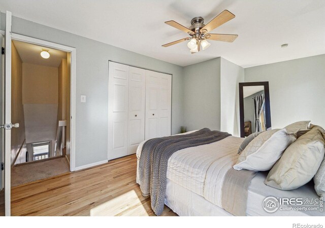 bedroom featuring light wood-type flooring, baseboards, a closet, and a ceiling fan