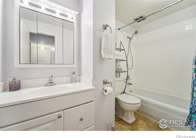 full bathroom featuring vanity, shower / bath combination with curtain, and toilet