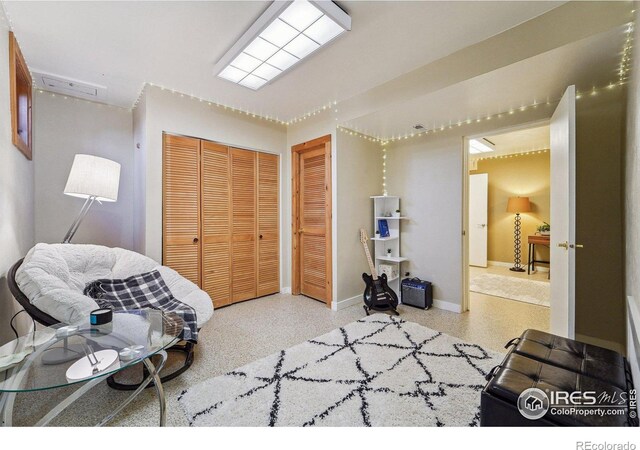 bedroom featuring speckled floor and baseboards