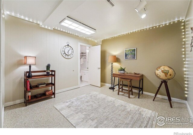 interior space with visible vents, speckled floor, and baseboards