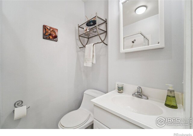 half bath featuring toilet and vanity