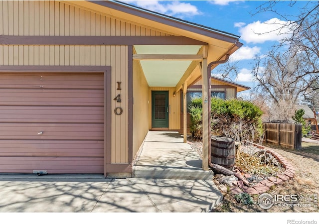 doorway to property featuring fence