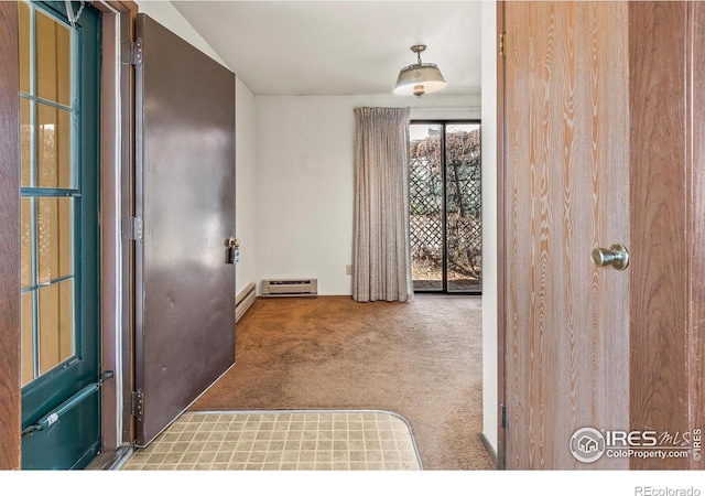 carpeted entrance foyer featuring baseboard heating