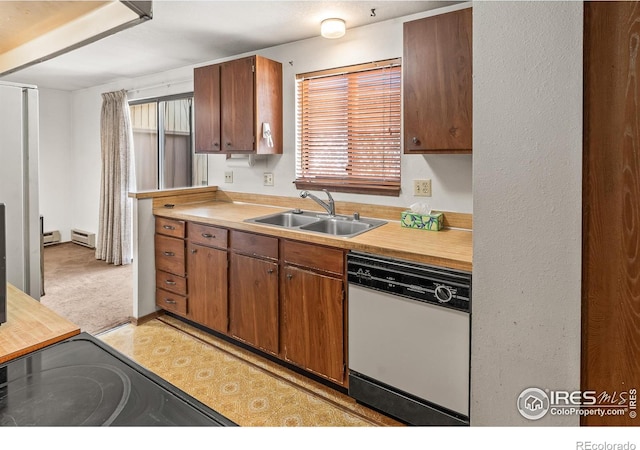 kitchen featuring a sink, stove, brown cabinetry, and white dishwasher