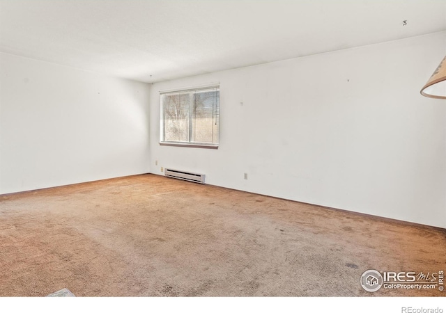 empty room featuring carpet flooring and a baseboard radiator