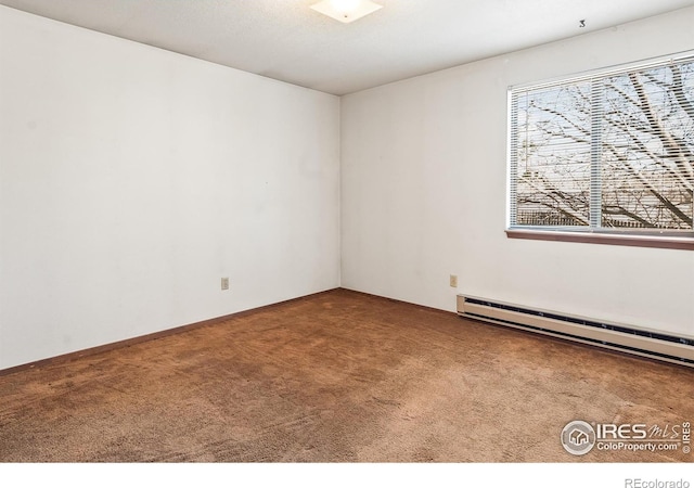 carpeted empty room featuring baseboard heating