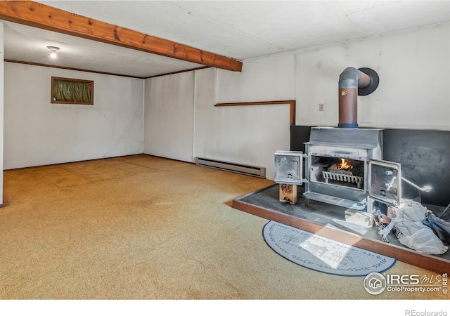 finished basement with a wood stove and a baseboard radiator