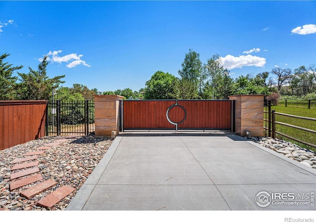 view of gate featuring fence