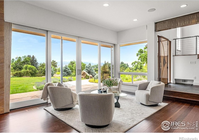 living room featuring recessed lighting, visible vents, and wood finished floors