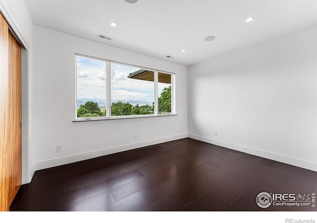 unfurnished room with recessed lighting, baseboards, and visible vents