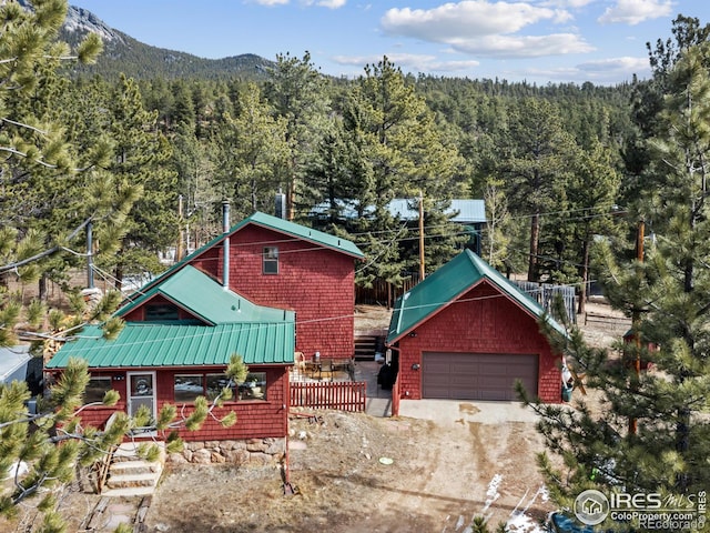 177 Bill Waite Rd, Allenspark, CO 80510 - chalet / cabin featuring a view of trees, metal roof, driveway, and a mountain view