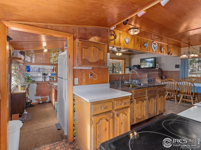 177 Bill Waite Rd, Allenspark, CO 80510 - kitchen featuring wooden walls, ceiling fan, a sink, carpet, and a peninsula