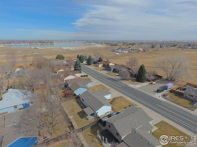 birds eye view of property with a water view and a residential view