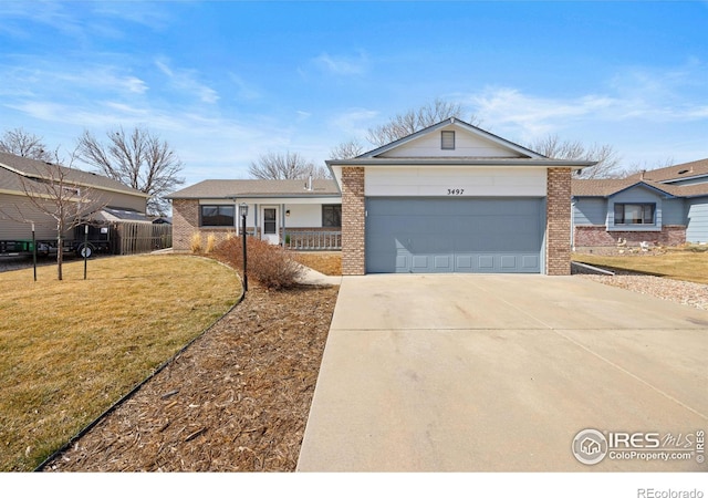 ranch-style house with a garage, a front lawn, concrete driveway, and brick siding