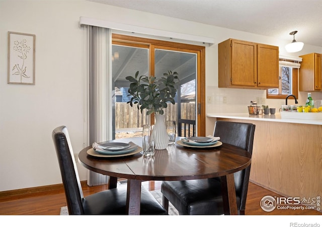 dining room featuring wood finished floors and baseboards